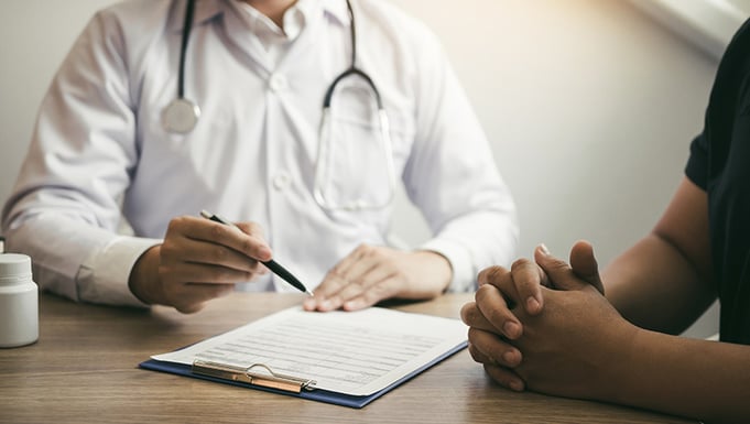Doctor seated with a patient
