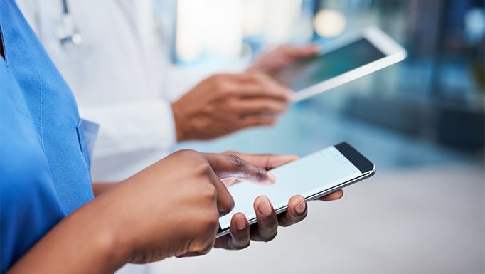 istock doctor and nurse looking at a cell phone