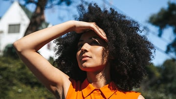 Woman blocking the sun with her hand