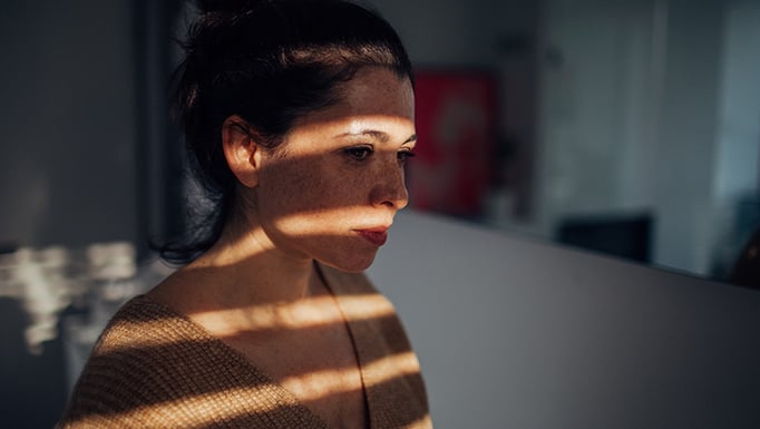 Woman in a darkened room