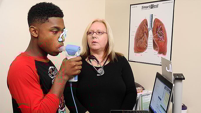 Pediatric asthma specialist B. Louise Giles, MD with a patient