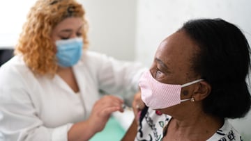 Clinician provides a vaccine to a patient