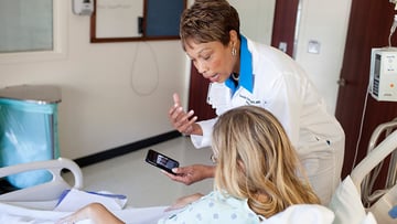 Transplant nurse coordinator with a patient after transplant surgery