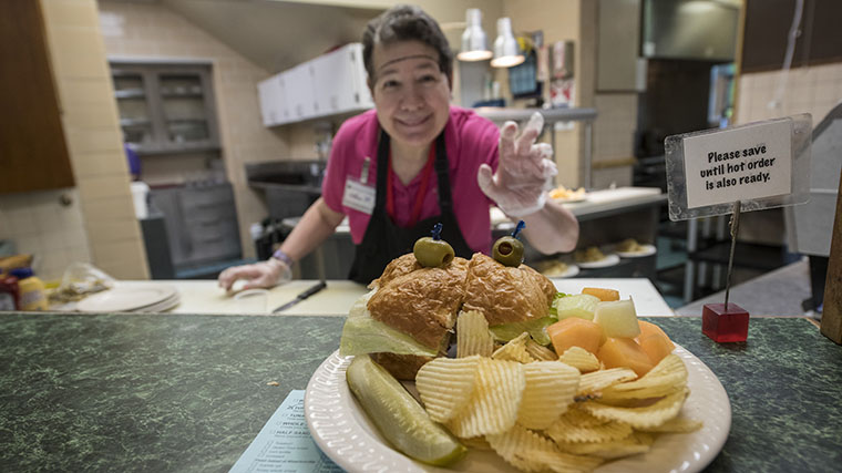 Image of Misericordia staff standing in the kitchen serving food