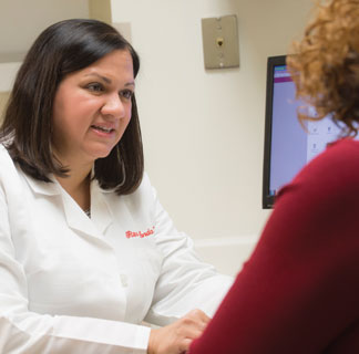 Oncologist Rita Nanda, MD, meets with a patient