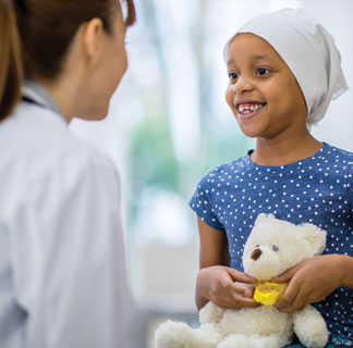 Young girl with head scarf, talking to clinician
