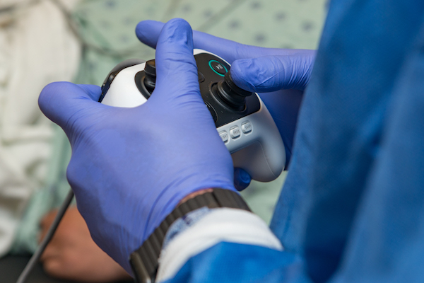Dr. Kyle Hogarth holds the Auris Monarch controller