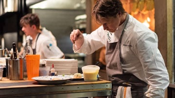 Chef Grant Achatz, head and neck cancer survivor, at work in the kitchen at Roister.