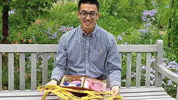 Pritzker student Daniel Lam with a knitting project