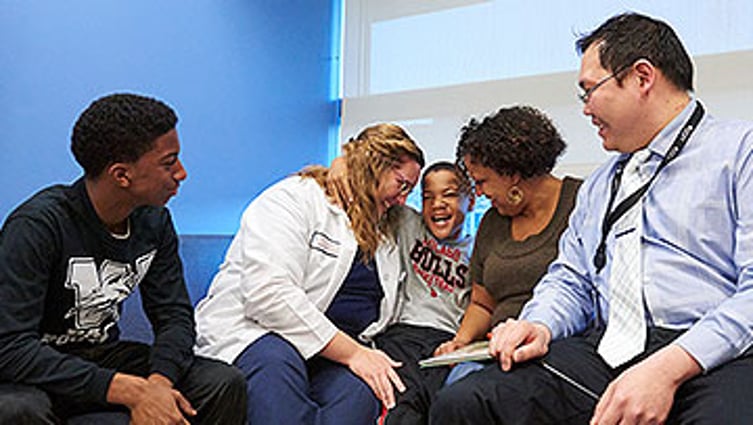 William Sterling, now seizure-free after starting a ketogenic diet, with his mom, brother, Dr. Chalongchai Phitsanuwong and nurse