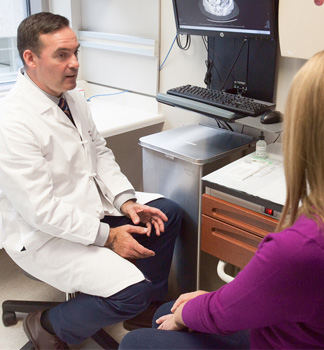 John Moroney, MD, and patient in clinic