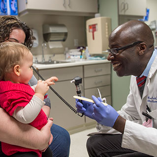 Plastic and reconstructive surgeon Russell Reid, MD, PhD., with Trish Lawson and her daughter Molly Lawson, 15 months old, at the Duchossois Center for Advanced Medicine (DCAM)