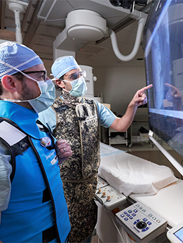 Drs. Paul and Ahmed review patient case