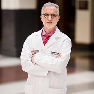 James Mastrianni, MD, PhD posing with arms crossed