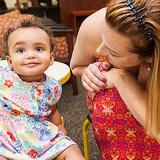 Kate McClinton leans in to her 1-year-old daughter