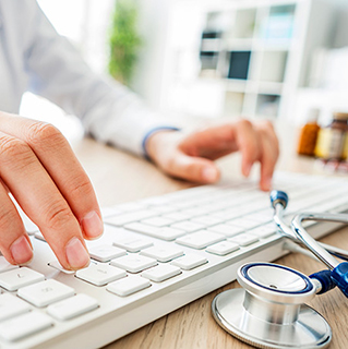 Doctor typing on computer