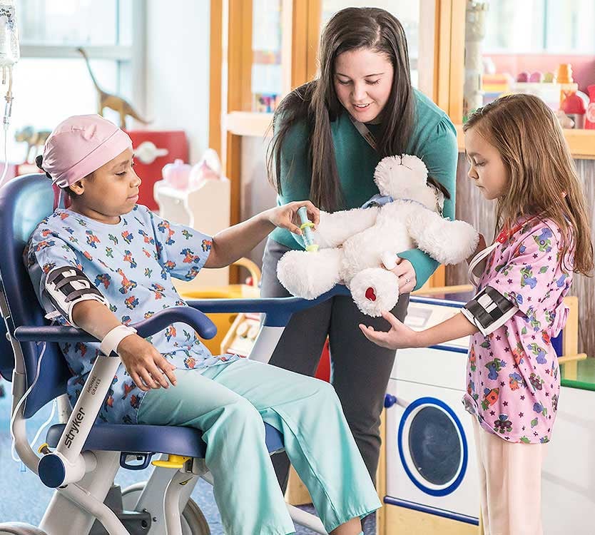 Child life specialist and patients enjoying play time at Comer Children