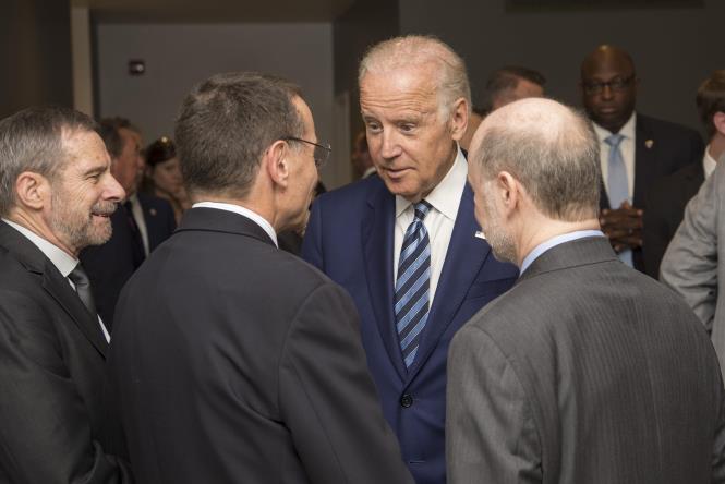 Vice President Joe Biden greets Kenneth Polonsky, MD, executive vice president for Medical Affairs, and Prof. Robert Grossman, MD, right, Department of Medicine and the College and Senior Fellow with the Computation Institute, as he arrives to launch the NCI Genomic Data Commons (GDC), a system designed and developed by the Center for Data Intensive Science at the University of Chicago and presented Monday, June 6, 2016, at their office in the Shoreland in Chicago. At left is Douglas Lowy, MD, acting director of the National Cancer Institute. (Photo by Robert Kozloff)