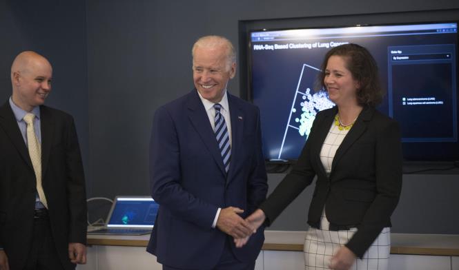 Vice President Joe Biden talks with Barbara Stranger, PhD, Piers Nash, right, both with GDC, as the vice president toured the NCI Genomic Data Commons (GDC), a system designed and developed by the Center for Data Intensive Science at the University of Chicago and presented Monday, June 6, 2016, at their office in the Shoreland in Chicago. (Photo by Robert Kozloff)