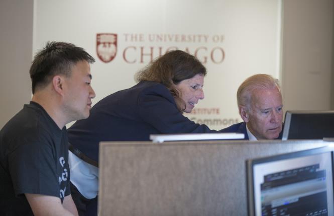 Vice President Joe Biden talks with Zhenyu Shang, PhD, and Sue Cohn, MD, as the vice president toured the NCI Genomic Data Commons (GDC), a system designed and developed by the Center for Data Intensive Science at the University of Chicago and presented Monday, June 6, 2016, at their office in the Shoreland in Chicago. (Photo by Robert Kozloff)