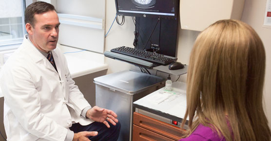 Gynecologic oncologist John Moroney, MD, and patient in clinic