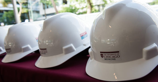 construction hard hats lined up on a table