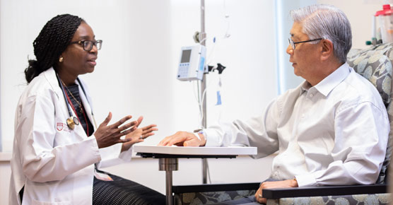 Olatoyosi Odenike, MD, and patient in infusion bay