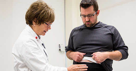 Josh Strand and Janice Colwell, RN, discuss his ostomy pouch at the Duchossois Center for Advanced Medicine