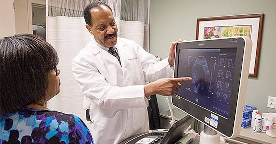 Dr. Nathaniel Crump reviewing a scan with a patient