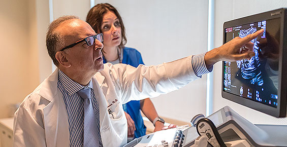 Fetal ultrasound expert Jacques Abramowicz, MD, pointing an image on a screen