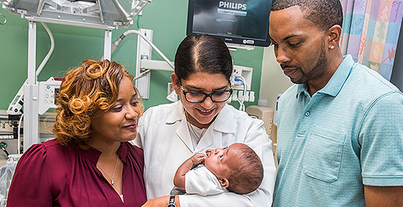 Dr. Sarosh Rana with a premature newborn and his parents