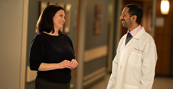 Reproductive endocrinologist Alberuni Zamah, MD, talking with a patient