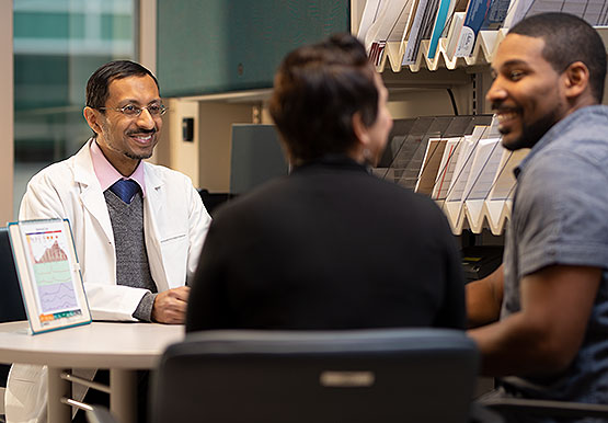 Reproductive endocrinologist Musa Zamah consulting with a couple