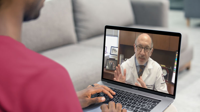 surgeon Jeffrey Matthews, MD, giving a telemedicine visit