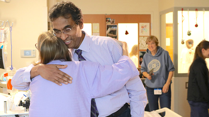 Triple-organ transplant patient, Sarah McPharlin, hugs her heart transplant surgeon, Dr. Valluvan Jeevanandam