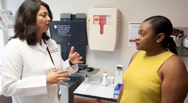 Nita Lee, MD, talking with patient
