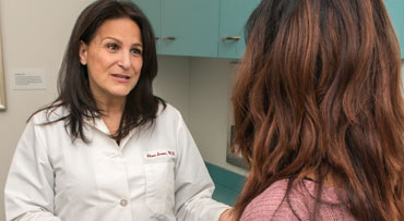 Shari Snow, MD, talking with patient