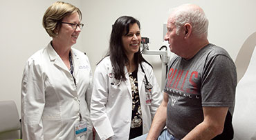 Two endocrinologists speaking with a patient