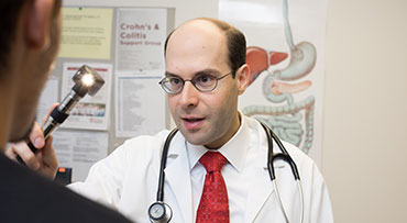 Dr. Robert Kavitt looking into a patient