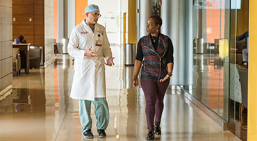 Dr. Vivek Prachand walking with a patient in the CCD