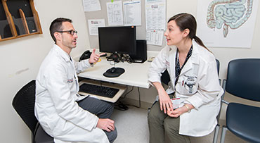 Dr. Andrew Aronsohn having a conversation with another UChicago Medicine doctor