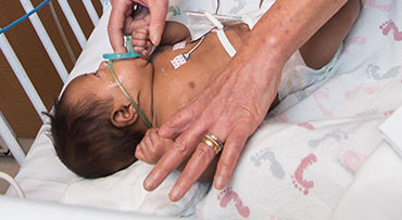 Physician holding a baby