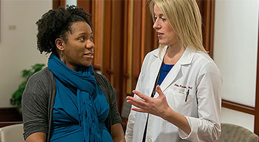 Obstetrician/gynecologist Abbe Kordik, MD, speaks with a pregnant patient