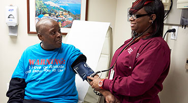 Medical assistant LaDonna White, right, assess a patient as part of the Comprehensive Care Physician (CCP) Model at the University of Chicago Medicine