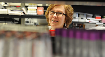 Portrait of physician Susana Marino, MD, PhD, D (ABHI), Associate Professor, Director, Transplant Immunology and Immunogenetics Lab, with an unidentified man in a lab