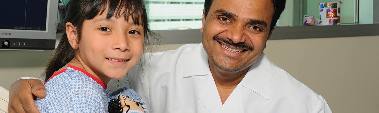 Pediatric urologist Mohan Gundeti, MD, with a patient