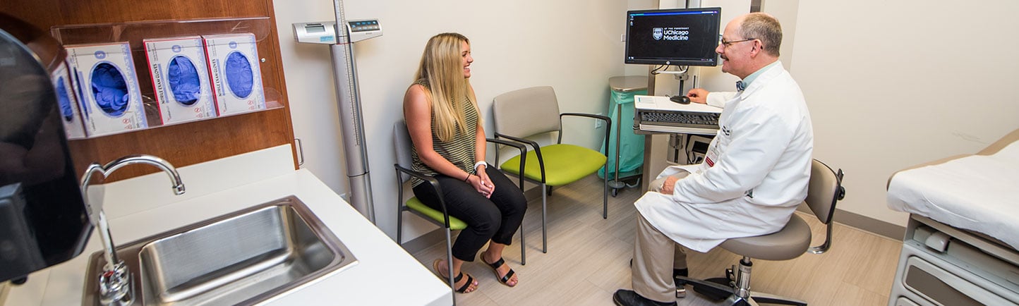 Physician with patient in exam room