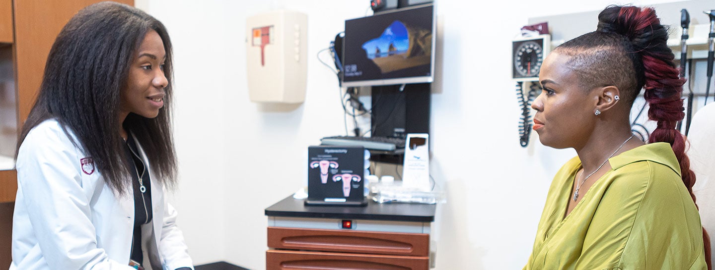 Gynecologic surgeon Sandra Laveaux, MD, MPH, talking with a patient