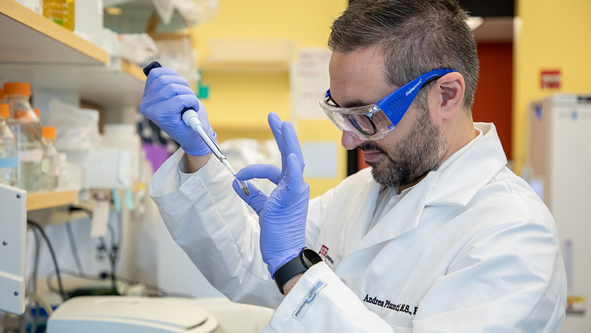 Image of Dr. Andrea Piunti conducting pediatric neurology research within a lab