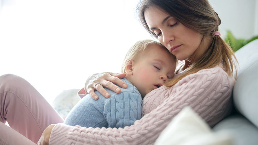 Image of mom holding her infant who is feeling symptoms of RSV